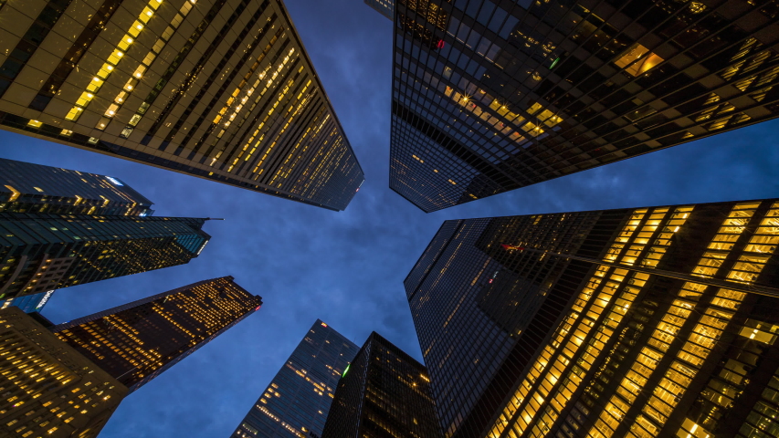 Business and finance concept, zoom out time lapse view looking up at modern office building architecture in the financial district of Downtown Toronto at dusk in Ontario, Canada. | Shutterstock HD Video #1056822200