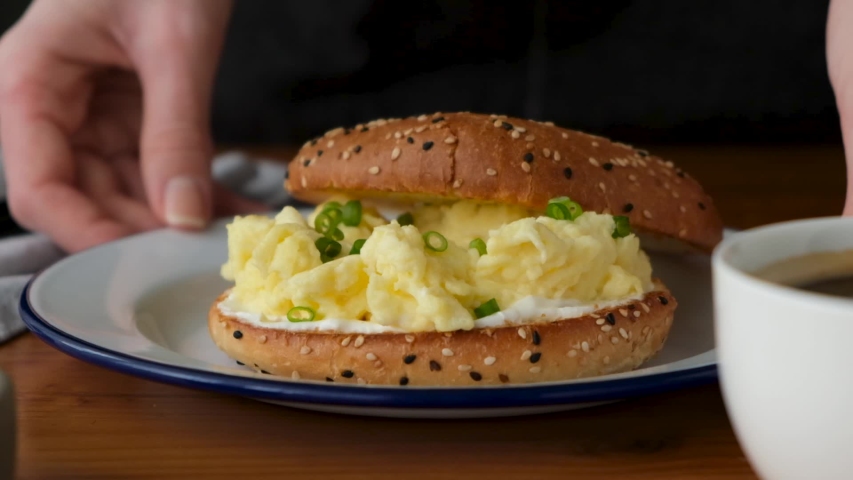 Bagel sandwich with scrambled egg and scallion. Tasty breakfast egg sandwich Royalty-Free Stock Footage #1056827765