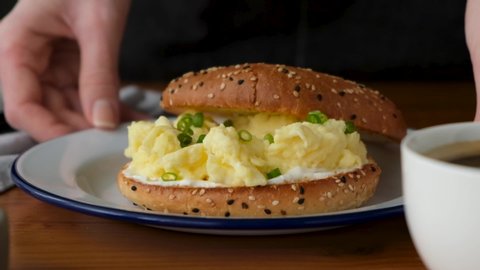 Bagel sandwich with scrambled egg and scallion. Tasty breakfast egg sandwich