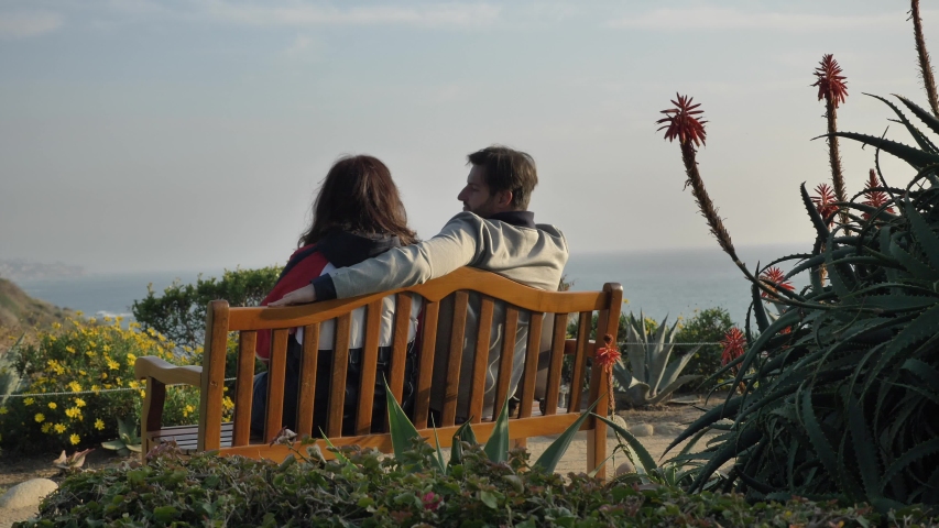 Couple on the bench at Laguna Beach amazing view with beautiful flowers