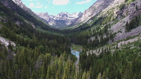 Grand Teton park, Jackson hole. View inside the park with the forest and lake inside the valley, mountains view. Mountains,USA. Nature, Landscape, Views. 4K Drone
