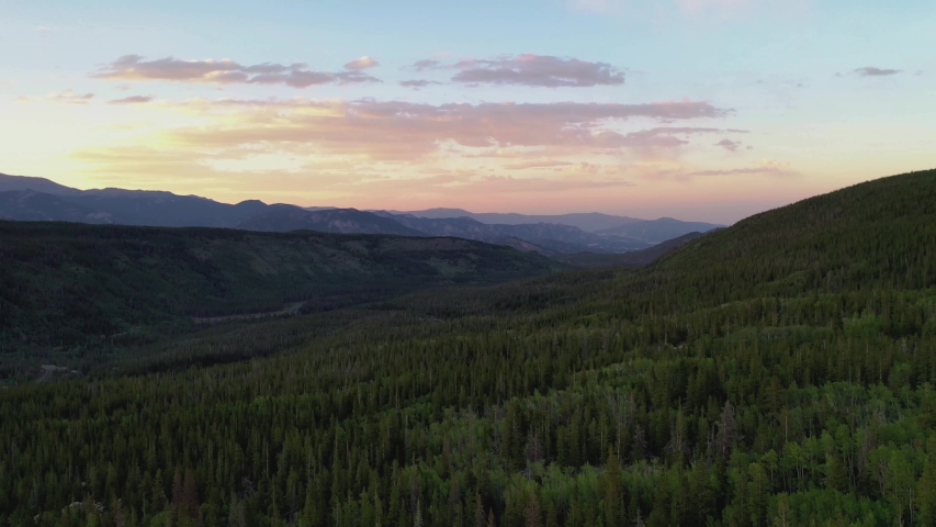 Rocky Mountains National Park. Mountain view of Rockies during the dusks. Forest, Snow, Mountains, Colorado, USA, Nature, Landscape, Views. 4K Drone footage