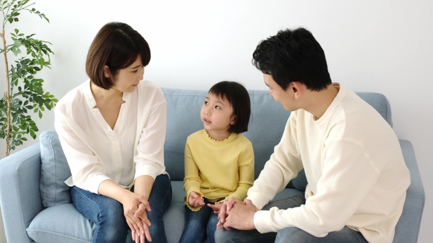 young asian family relaxing at living room