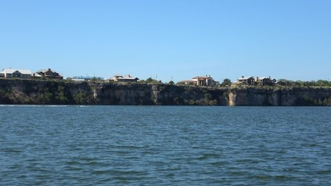 View of stone shore  on Possum Kingdom Lake in the summer. View from boat.