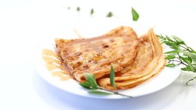 fried thin pancakes with sweet caramel in a plate