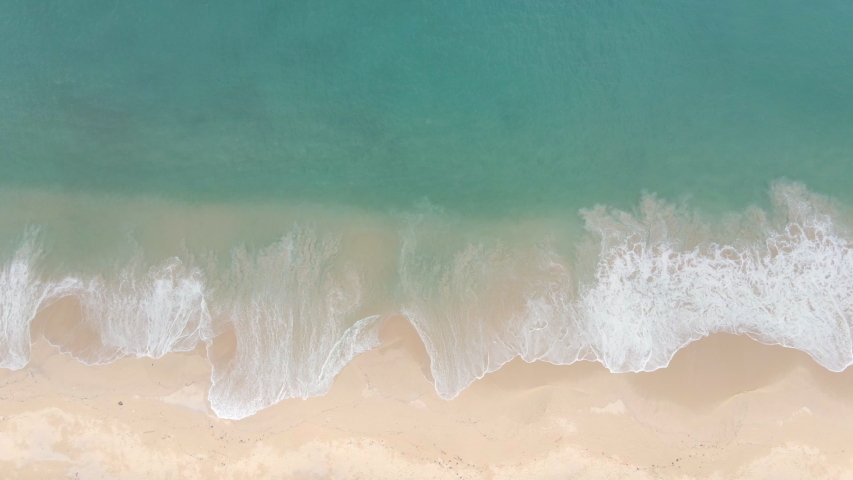 4K UHD Aerial view top view Beautiful topical beach with white sand. Top view empty and clean beach. Beautiful Phuket beach is famous tourist destination at Andaman sea. | Shutterstock HD Video #1056839804