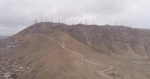 Aerial video with drone of a hill with antennas in Lima Peru. Communication infraestructure fo radio signal.