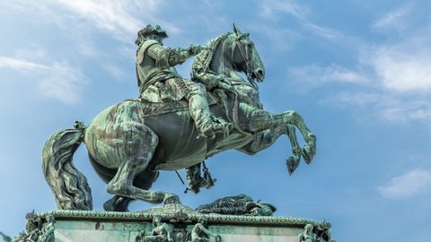 Equestrian statue of Prince Eugene of Savoy timelapse hyperlapse (Prinz Eugen von Savoyen) in front of Hofburg palace, Heldenplatz, Vienna, Austria. Blue cloudy sky