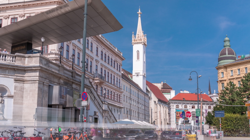 Albertina Square aerial timelapse with historic buildings, tower, tourist buses, people and traffic in downtown Vienna, Austria