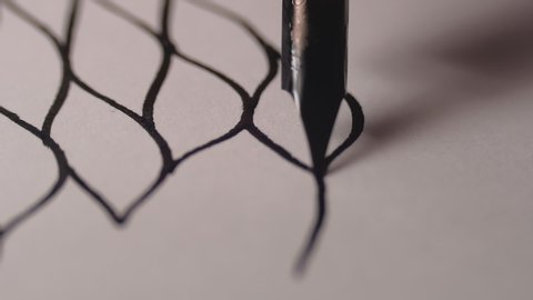 Close up of dip pen drawing ink lines. Macro shot.
