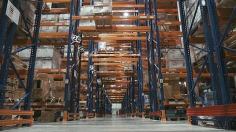 Warehouse with cardboard boxes inside on pallets racks, logistic center. Huge, large modern warehouse. Warehouse filled with cardboard boxes on shelves
