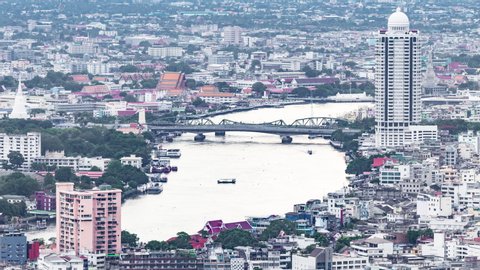 Timelapse of aerial view of Bangkok city over Chao Phraya River and also Memorial Bridge and Phra Pok Klao Bridge