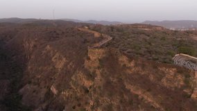 Jaipur pink city aerial panoramic. Sunset 4k footage of beautiful skyline in historic city. Birds eye view of scenic landscapes from nahargarh fort in Jaipur, Rajasthan, India