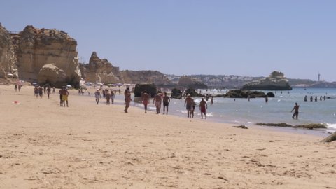 Crowd Enjoying Beach of Portimao In Algarve, Portugal. Crowd enjoying sunny day at the beach of Portimao in the Algarve region, Portugal