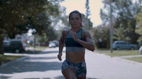 Running as fast as you can. Confident and powerful woman running with determination and focus.Shot in 4k