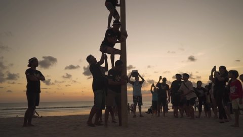 Bali, Indonesia - August 17 2019: Indonesia Independence Day, Indonesian People Celebrating National Holiday Anniversary 17 August 1945 - Panjat Pinang Greasy Pole Game