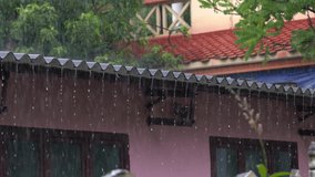 Heavy rain falling on the roof of a house