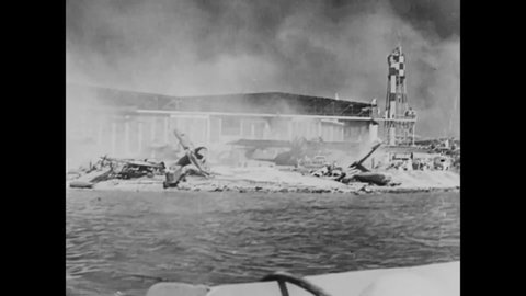 CIRCA 1941 - In this documentary directed by Frank Capra, burning wreckage of the Pearl Harbor attacks and wounded American sailors are shown.
