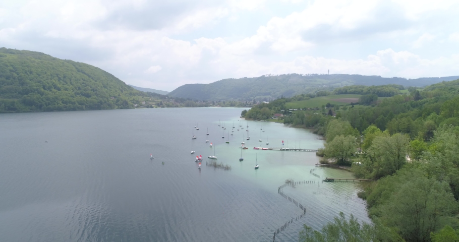 Yachting on Paladru lake, aerial approach, Isère, France Royalty-Free Stock Footage #1056877028