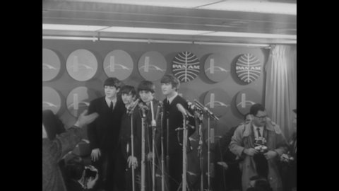 CIRCA 1964 - The Beatles hold a press conference in New York while fans scream outside, then visit Central Park.