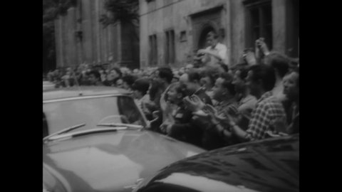CIRCA 1964 - Huge crowds in Warsaw, Poland throng the Kennedys' car and ask for autographs from Bobby and his kids.