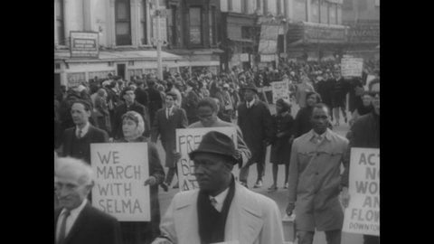 CIRCA 1965 - Black and white protestors march in Harlem, New York in solidarity with Selma, mourning the murder of Reverend James J. Reeb.