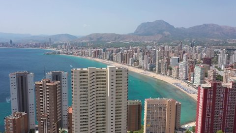 Spain, Benidorm, drone aerial view flying through hotels to Llevant beach