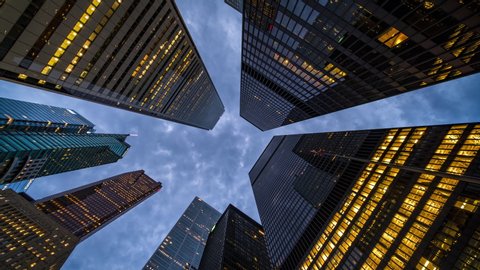 Business and finance concept, moody time lapse view looking up at modern office building architecture in the Toronto financial district, Ontario, Canada.