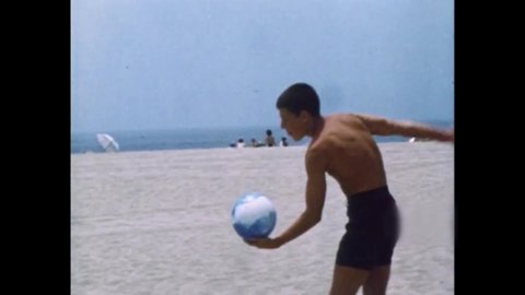 CIRCA 1967 - Teenagers play volleyball, go surfing, and enjoy a cookout at the beach.