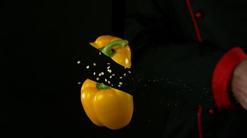 Super Slow Motion Shot of Chef Chopping Yellow Pepper in the air at 1000 fps.