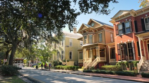 Savannah, Georgia, USA – November 28, 2019:  Tree lined historic homes on a residential street in Savannah Georgia USA