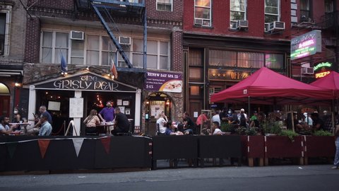 New York / USA - Aug 1, 2020: NYC Greenwich Village outdoor dining during Coronavirus ("Covid-19") pandemic reopening Phase 4. Bars and Cafes on McDougal Street.
