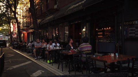 New York / USA - Aug 1, 2020: NYC Greenwich Village outdoor dining during Coronavirus ("Covid-19") pandemic reopening Phase 4. Bars and Cafes on West 3rd Street and McDougal.