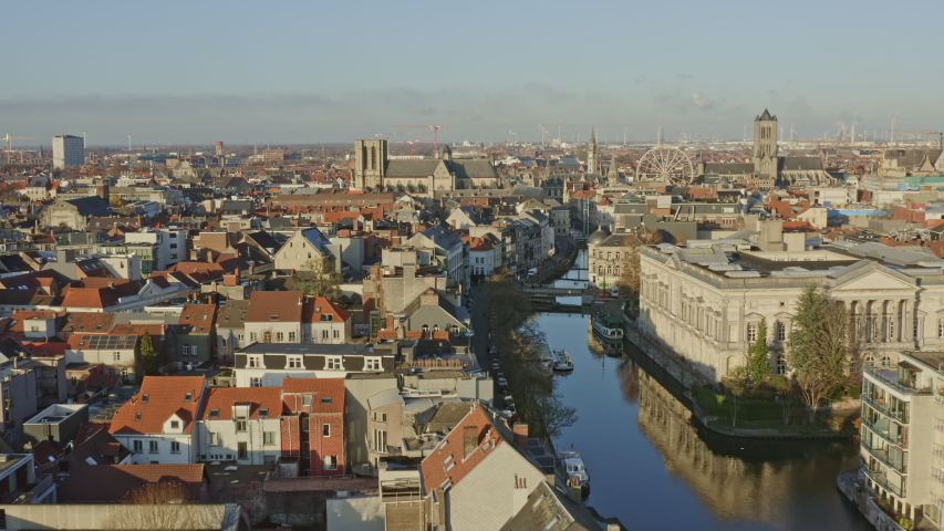 Ghent Belgium Aerial  Flying low over Leie canal neighborhood into downtown with cityscape views - November 2019