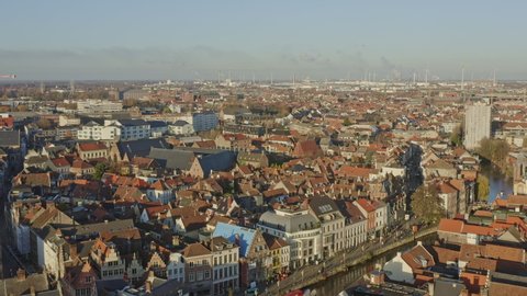 Ghent Belgium Aerial  Flying low over Leie canal neighborhood into downtown with cityscape views - November 2019