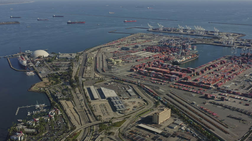 Long Beach CA Aerial  Traversing over shipyard port industrial cityscape toward ocean in near birdseye perspective - October 2019