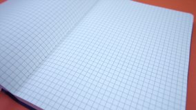 Movement around an open squared notebook - Powered by Shutterstock - Get 15% off with code: PIKWIZARD15
