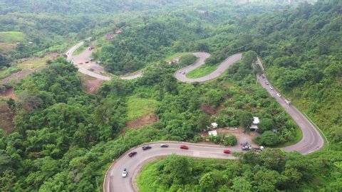 Footage B roll of Aerial view drone flying above landscape serpentine winding road. a car driving in the winding road. Drone 4K Video. road winding on the mountains in summer sunny day.