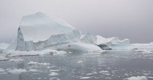 Global Warming and Climate Change - Hyperlapse of Icebergs and ice from melting glacier in icefjord in Ilulissat, Greenland. Aerial video of arctic nature ice landscape. Unesco World Heritage Site.