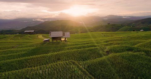Aerial view of view  sunset at Terraced Rice Field in Ban Pa Pong Piang , Mae Chaem District, Chiang Mai Province , Thailand. 4k drone footage Terraced Rice Field at sunset with clouds rain