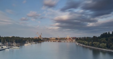 timelapse panorama of the evening city. Mykolaiv, Ukraine. Nikolaev. beautiful sky and ferries are running. summer evening. time lapse ultra high definition 4k	

