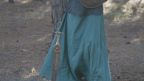 Portrait of Viking woman Warrior, slow motion Viking woman with sword in forest