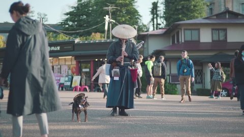 Kyoto / Japan - 04 15 2019: Maruyama Park,kyoto,japan,Yasaka Shrine,famous,japanese,samurai,dog,flute,man,shakuhachi,flutist,flautist,Samurai Dog,Flute Man,traditonally,dressed,asia,asian,daytime,anim