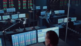 Professional Financial Data Analysts Working in a Modern Monitoring Office with Live Analytics Feed on a Big Digital Screen. Monitoring Room with Finance Specialists Sit in Front of Computers. - Powered by Shutterstock - Get 15% off with code: PIKWIZARD15