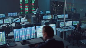 Professional Financial Data Analysts Working in a Modern Monitoring Office with Live Analytics Feed on a Big Digital Screen. Monitoring Room with Finance Specialists Sit in Front of Computers. - Powered by Shutterstock - Get 15% off with code: PIKWIZARD15