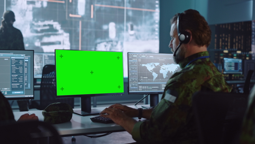 Military Surveillance Officer Working on Computer with Green Screen in Central Office for Cyber Operations, Control and Monitoring for Managing National Security, Technology and Army Communications. Royalty-Free Stock Footage #1056907823