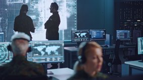 Shifting Focus Between Military Surveillance Officers Working in a Central Office Hub for Cyber Operations, Control and Monitoring for Managing National Security, Technology and Army Communications. - Powered by Shutterstock - Get 15% off with code: PIKWIZARD15