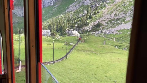 Beautiful landscape scenery seen through window of cog railway at Alpnachstad, Switzerland. High quality 4k footage