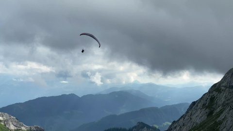 Paragliding over beautiful mountains against sky at Alpnachstad, Switzerland. High quality 4k footage