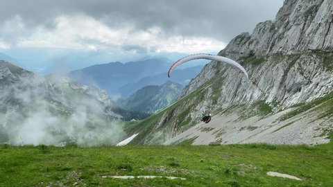 Paraglider flying over beautiful Pilatus mountain at Alpnachstad, Switzerland. High quality 4k footage